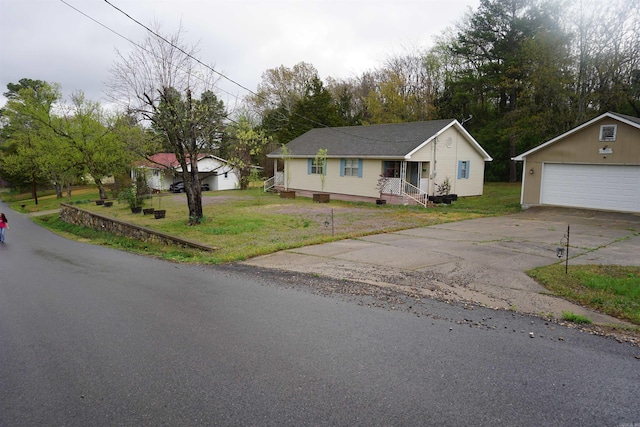 ranch-style home with an outdoor structure, a front lawn, a detached garage, and driveway