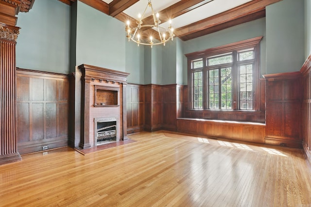 320 W 18th St, Little Rock, AR 72206 - unfurnished living room with beamed ceiling, hardwood / wood-style floors, a chandelier, a fireplace with flush hearth, and wainscoting