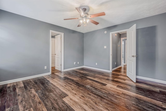 spare room featuring a ceiling fan, baseboards, and wood finished floors