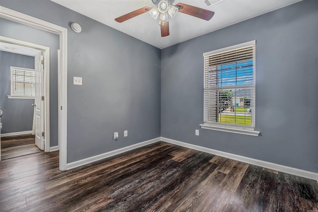 spare room featuring baseboards, a ceiling fan, wood finished floors, and a smoke detector