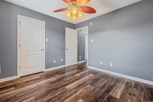 unfurnished bedroom featuring wood finished floors, baseboards, and ceiling fan