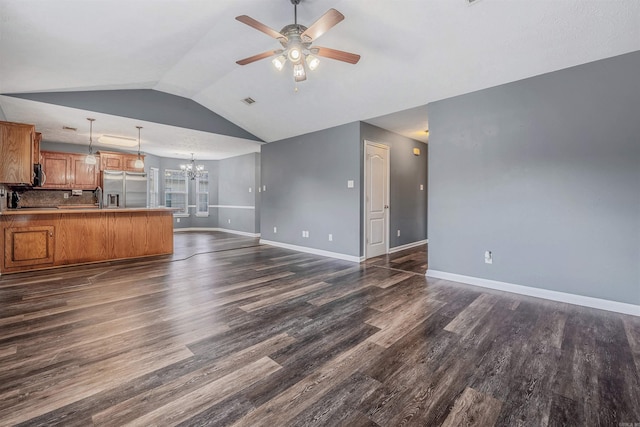 unfurnished living room featuring a ceiling fan, a chandelier, dark wood-style floors, baseboards, and lofted ceiling