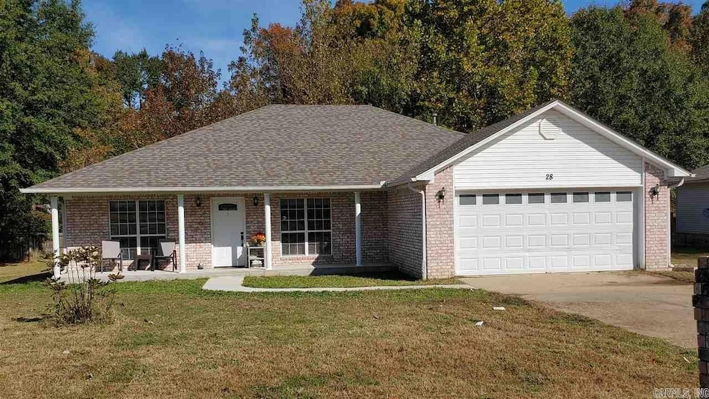 28 Woodbridge Dr, Cabot, AR 72023 - ranch-style home featuring brick siding, an attached garage, and a front yard
