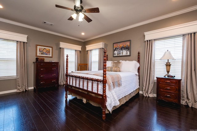 bedroom with baseboards, wood finished floors, multiple windows, crown molding, and recessed lighting