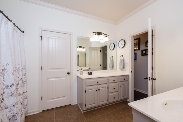 bathroom with vanity, ornamental molding, tile patterned flooring, and baseboards