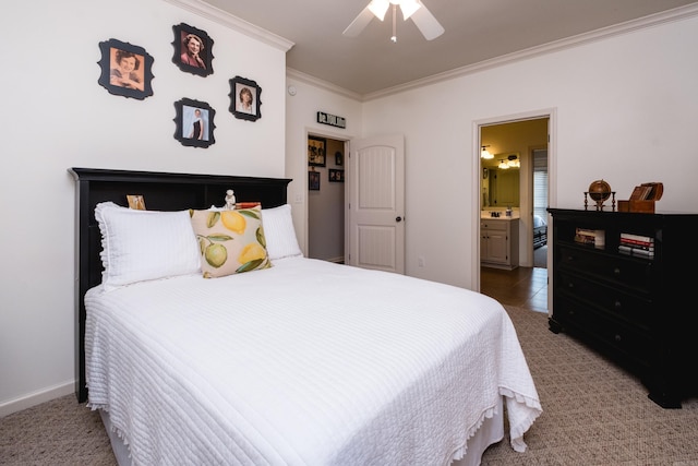 carpeted bedroom with ornamental molding, ensuite bath, and ceiling fan