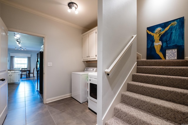 washroom with independent washer and dryer, crown molding, light tile patterned flooring, and cabinet space