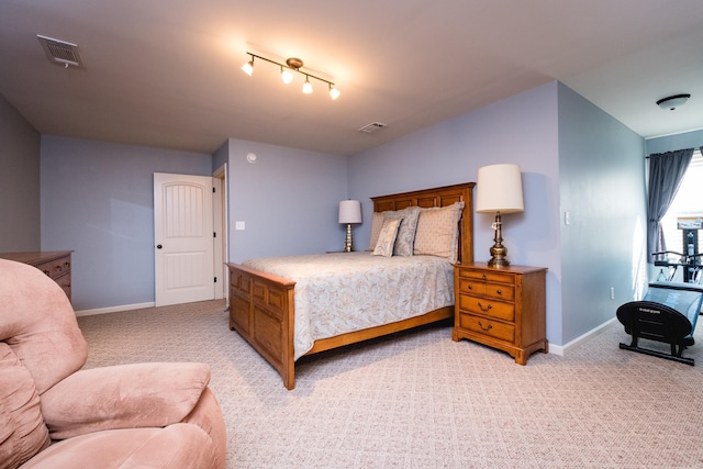 bedroom featuring light carpet and baseboards