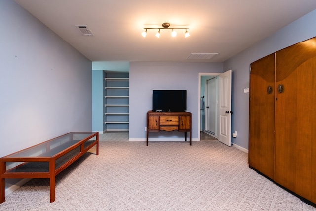 living room featuring light carpet and baseboards
