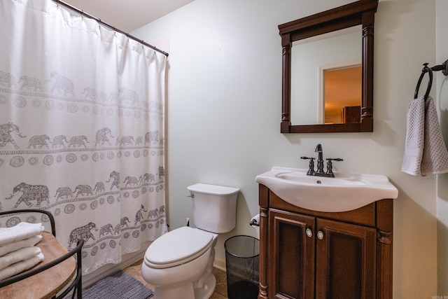 bathroom featuring toilet, vanity, and a shower with shower curtain