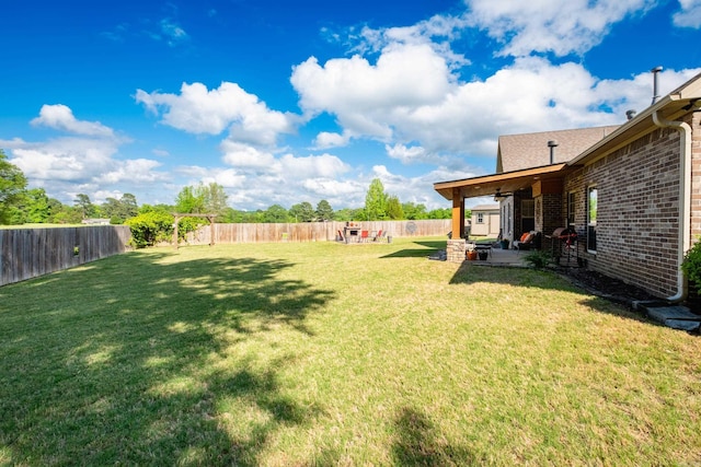 view of yard with a patio and a ceiling fan