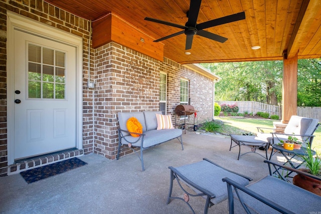 view of patio / terrace with fence and a ceiling fan