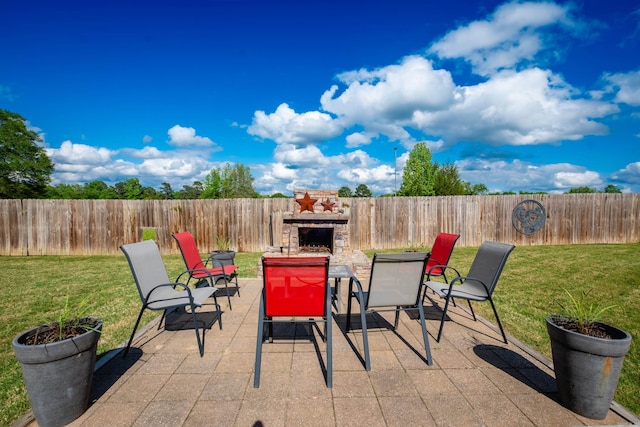 view of patio with an outdoor fireplace