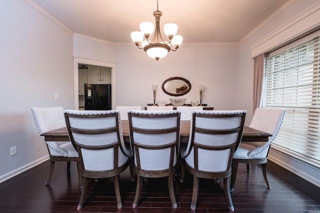 dining room featuring a chandelier, crown molding, dark wood-type flooring, and baseboards