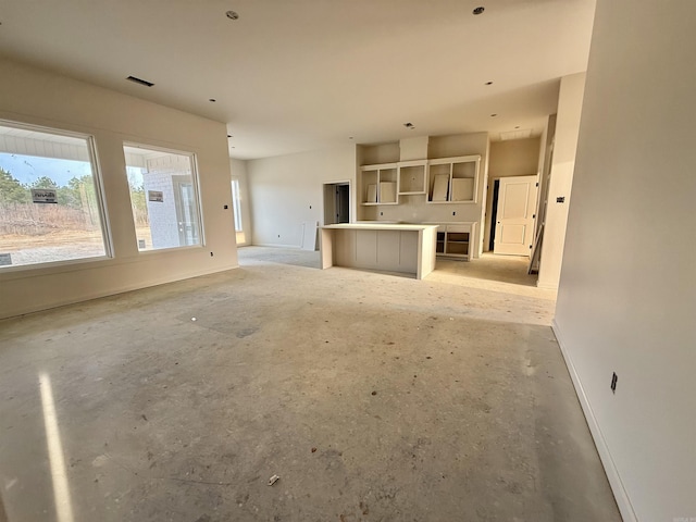 238 Kelton St, Hensley, AR 72065 - unfurnished living room featuring baseboards and concrete floors