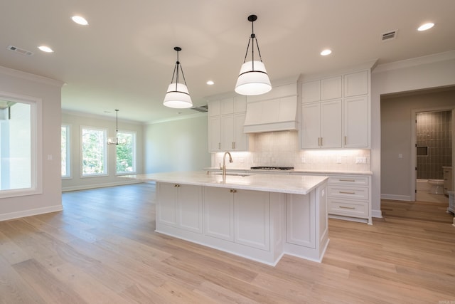 20 Abington Ct, Little Rock, AR 72223 - kitchen with ornamental molding, a sink, custom exhaust hood, baseboards, and light wood-type flooring