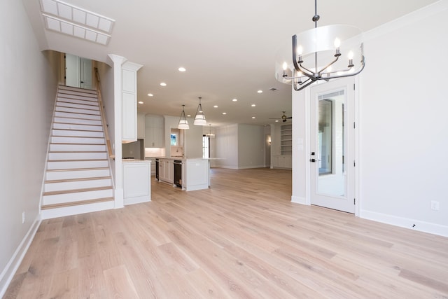 20 Abington Ct, Little Rock, AR 72223 - unfurnished living room with a chandelier, baseboards, light wood-style flooring, recessed lighting, and stairs