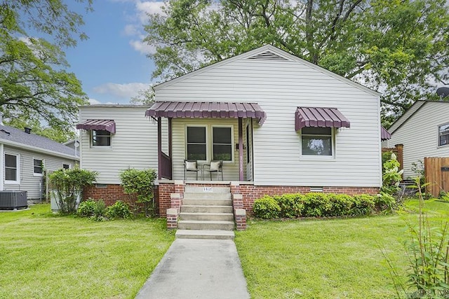 bungalow-style house with central air condition unit