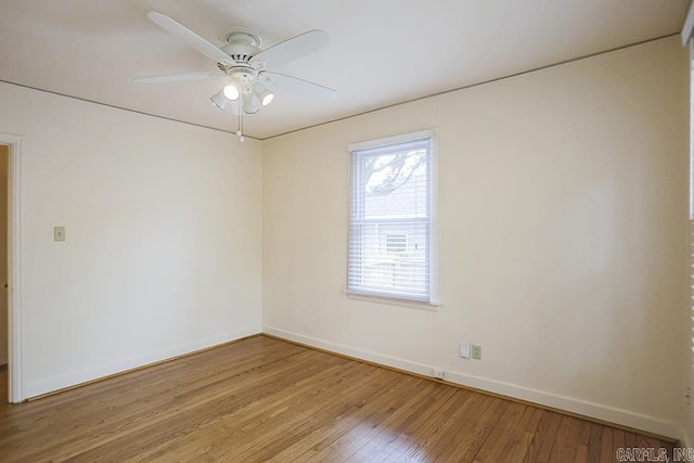 empty room with baseboards, light wood-style floors, and ceiling fan