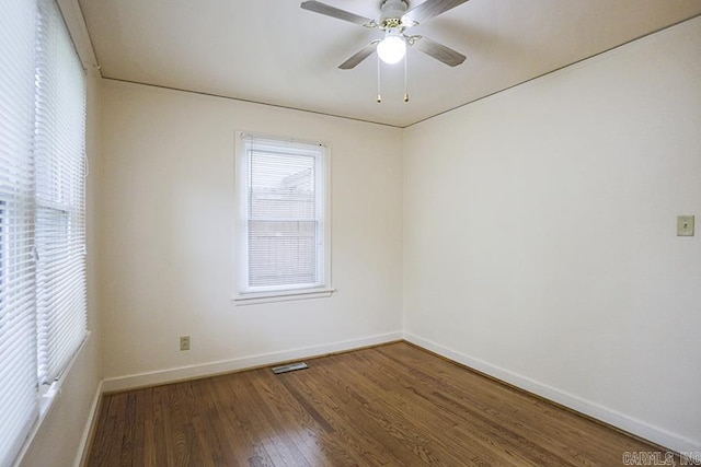 unfurnished room featuring baseboards, wood finished floors, and a ceiling fan