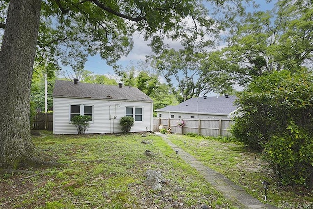 rear view of property with fence