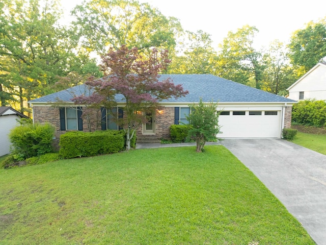 single story home featuring concrete driveway, an attached garage, a front lawn, roof with shingles, and brick siding