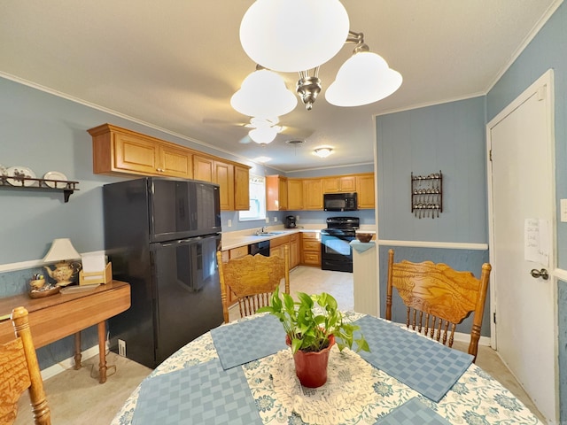 kitchen with black appliances, crown molding, light countertops, a sink, and a ceiling fan