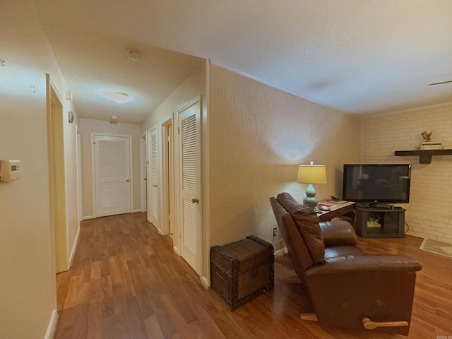 corridor with wood finished floors and baseboards