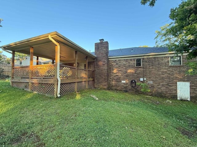 view of green lawn with a deck