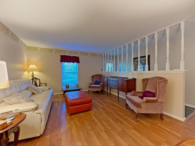 living room featuring light wood-style flooring and baseboards