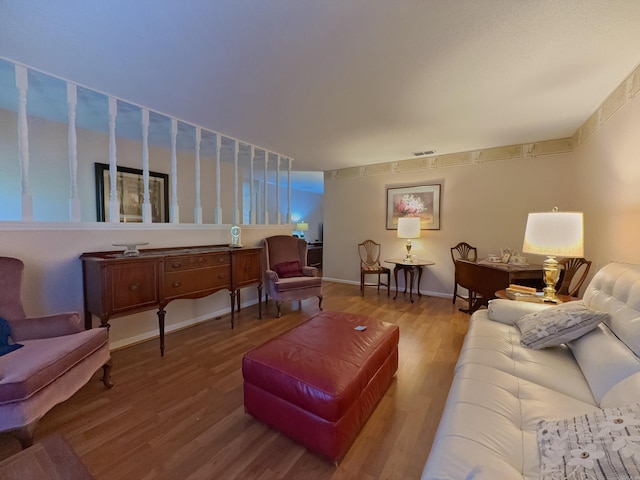 living room with wood finished floors and baseboards