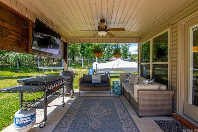 view of patio with an outdoor living space and a ceiling fan