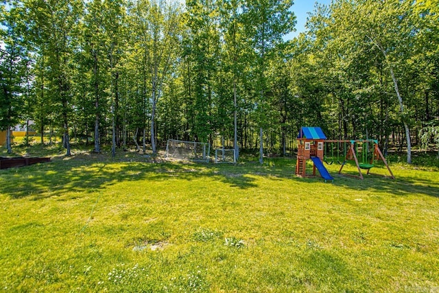 view of grassy yard with a playground