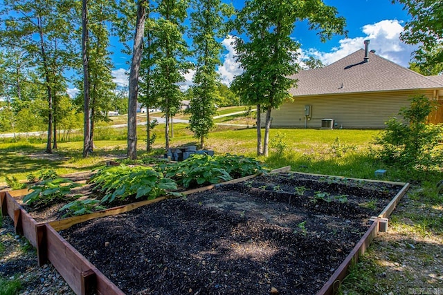 view of green lawn featuring a garden and cooling unit