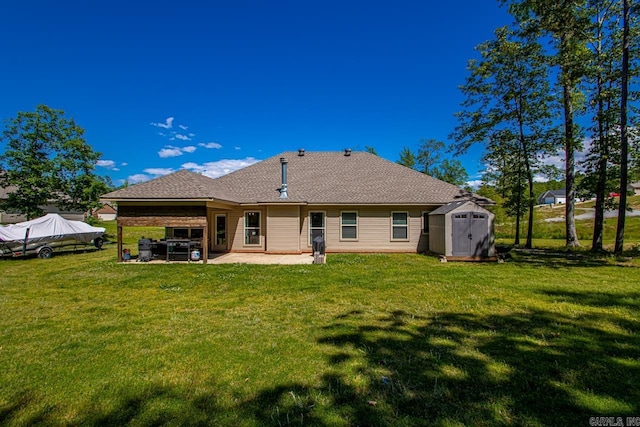 rear view of house featuring a storage unit, a patio, a lawn, and an outbuilding