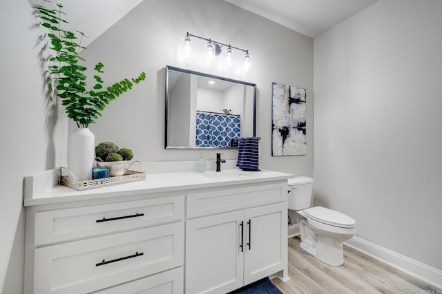 bathroom featuring wood finished floors, toilet, baseboards, vanity, and a shower with shower curtain