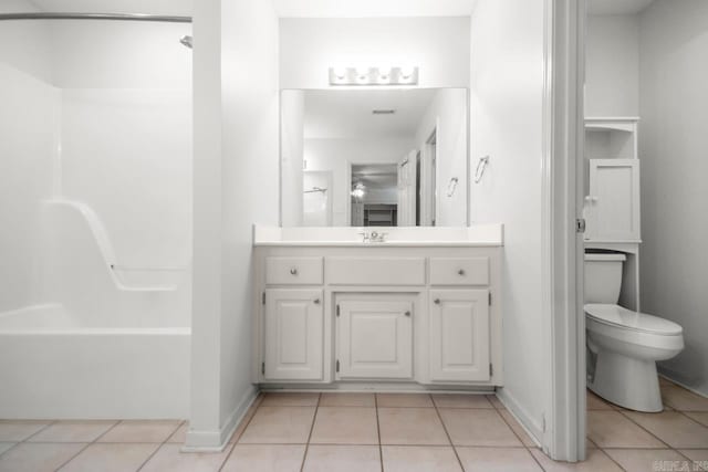 bathroom with tile patterned floors, toilet, vanity, and baseboards