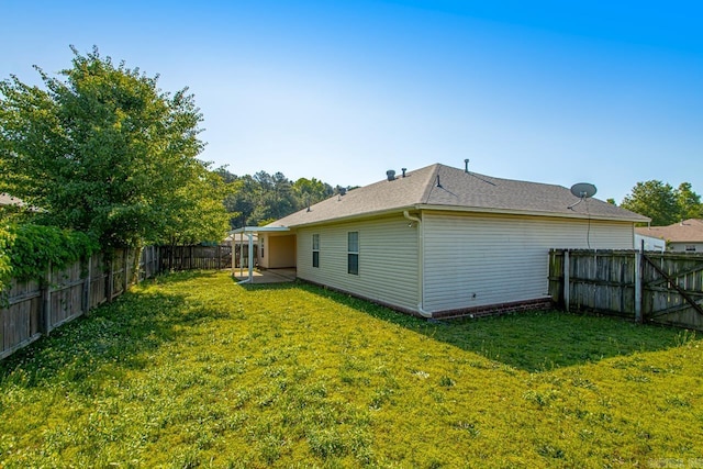 rear view of house featuring a shingled roof