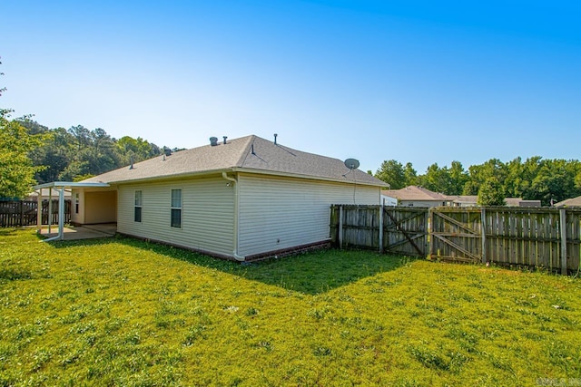 rear view of house with a patio area and a shingled roof