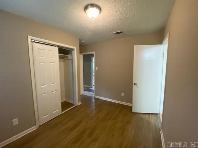 3804 Arapaho Trl, Little Rock, AR 72209 - unfurnished bedroom with wood finished floors, baseboards, a textured ceiling, and a closet
