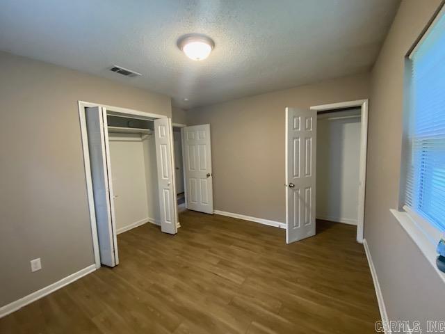 3804 Arapaho Trl, Little Rock, AR 72209 - unfurnished bedroom featuring wood finished floors, baseboards, and a closet