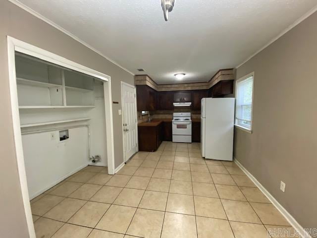 3804 Arapaho Trl, Little Rock, AR 72209 - kitchen with white appliances, crown molding, light tile patterned flooring, dark brown cabinets, and under cabinet range hood