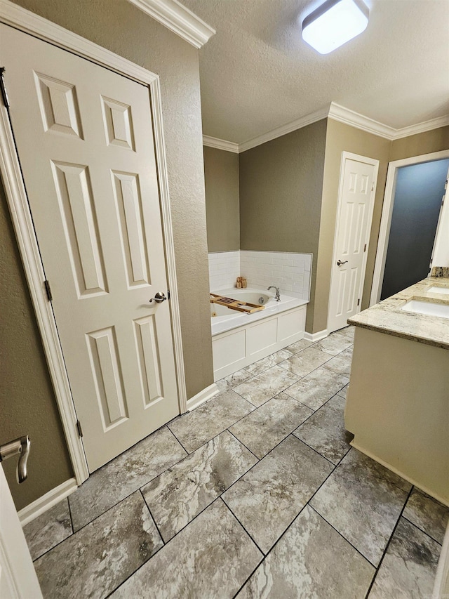 full bath featuring crown molding, a bath, a textured ceiling, a textured wall, and baseboards
