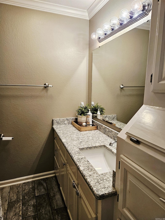 bathroom with crown molding and vanity