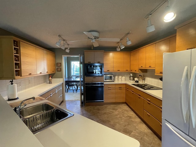 1502 Quail Creek Dr, Conway, AR 72032 - kitchen with black appliances, track lighting, a sink, light countertops, and a textured ceiling