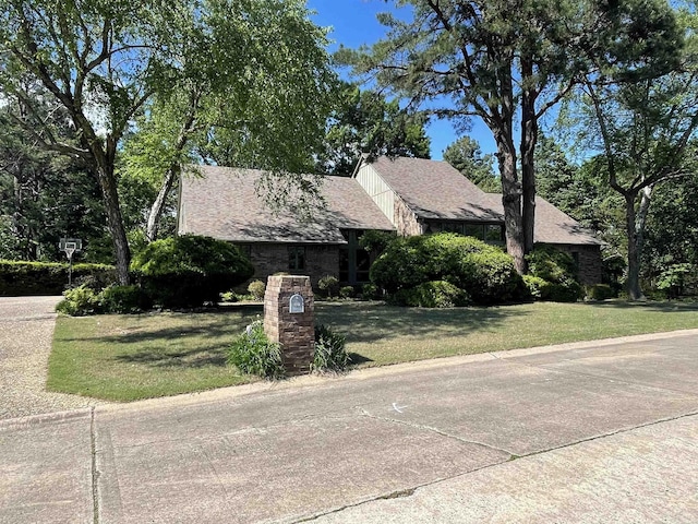 1502 Quail Creek Dr, Conway, AR 72032 - view of front of house with a front yard and a shingled roof