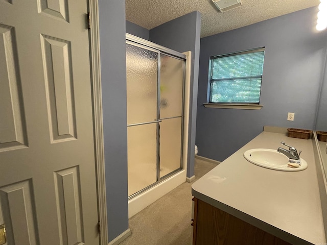 1502 Quail Creek Dr, Conway, AR 72032 - bathroom featuring toilet, vanity, a shower stall, and a textured ceiling