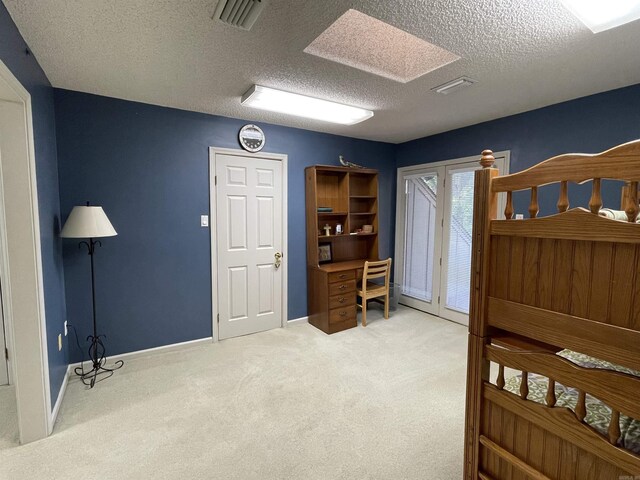 1502 Quail Creek Dr, Conway, AR 72032 - carpeted bedroom featuring access to outside, a textured ceiling, and baseboards