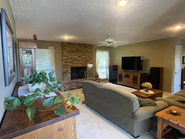 1502 Quail Creek Dr, Conway, AR 72032 - living area featuring a textured ceiling, carpet flooring, a ceiling fan, a fireplace, and recessed lighting
