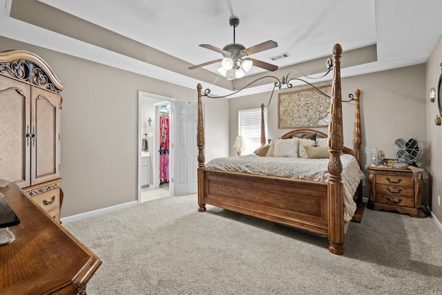 bedroom featuring carpet floors, baseboards, ensuite bathroom, and ceiling fan